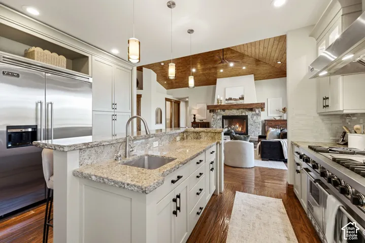 Gourmet kitchen with stainless steel appliances, light-toned cabinetry, and granite countertops