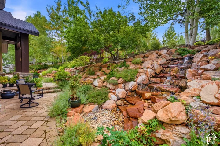 Terraced rock garden with a cascading water feature and mature plantings