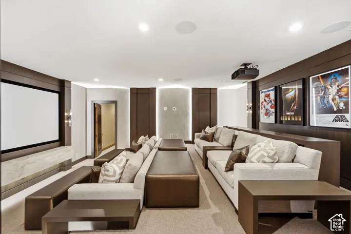 Dedicated media room featuring a projection screen, built-in projector, and recessed lighting