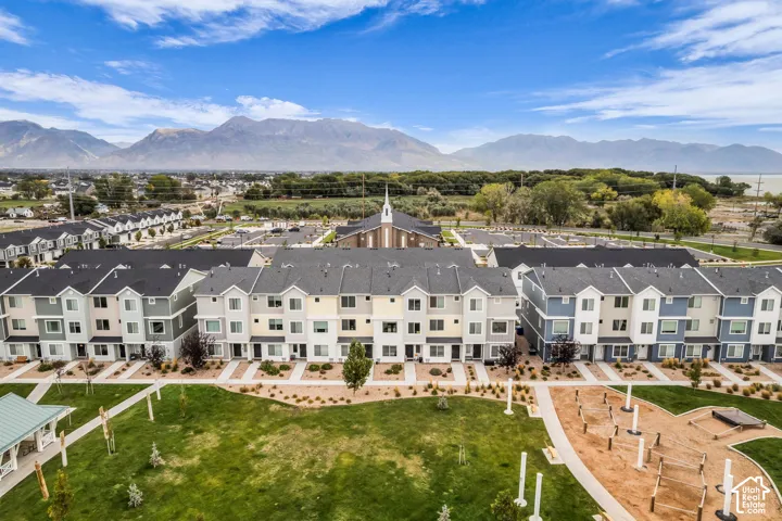 Modern townhome community featuring varied exterior color palettes and an expansive central green space