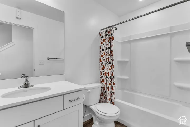 Bathroom featuring a white vanity with an integrated sink, polished chrome faucet, and white countertop