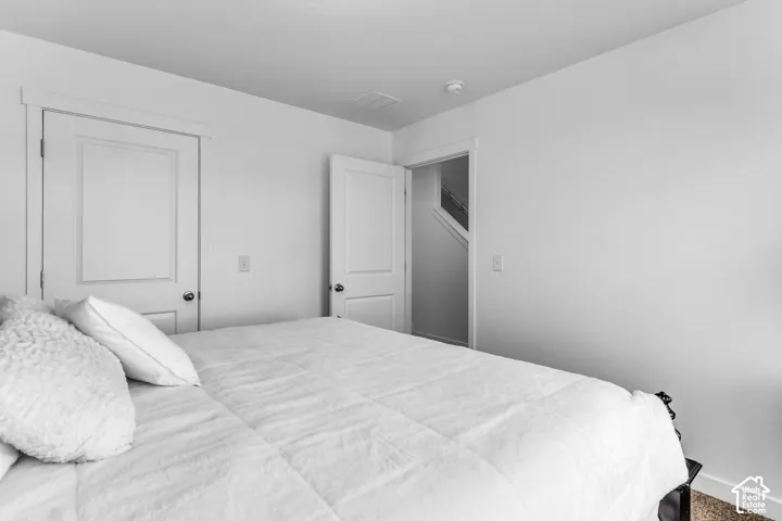 White interior walls with white trim, paneled interior doors, and a ceiling-mounted smoke detector