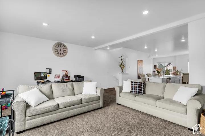 Recessed lighting, white walls, and carpeted flooring