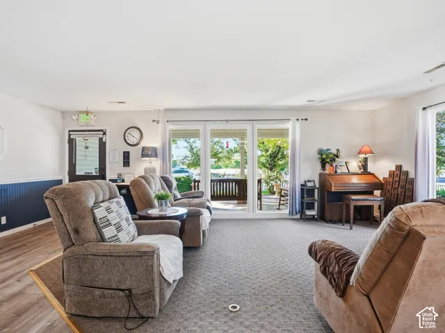 Wood-finish flooring, half-wall wainscoting, and large sliding glass doors
