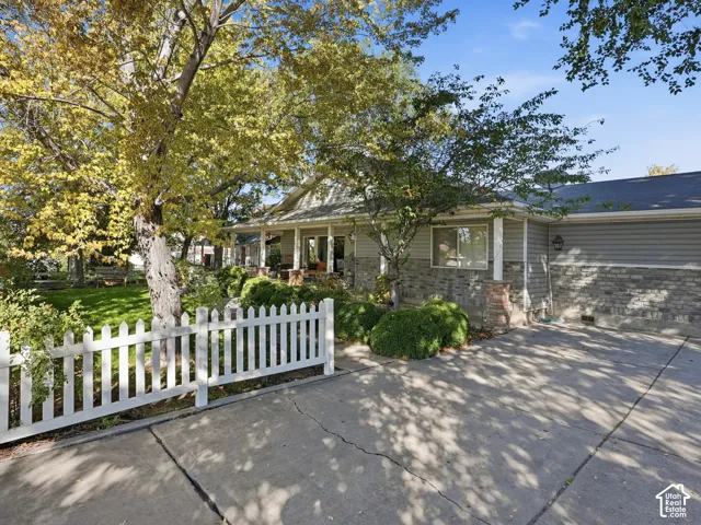 Ranch-style exterior with gray horizontal siding and stone veneer accents