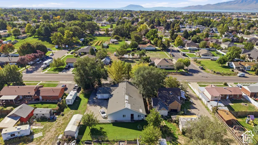 Expansive residential area with a prominent central structure, surrounded by mature trees and varied landscaping