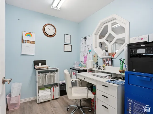 Wood-finish flooring with light blue walls and white trim