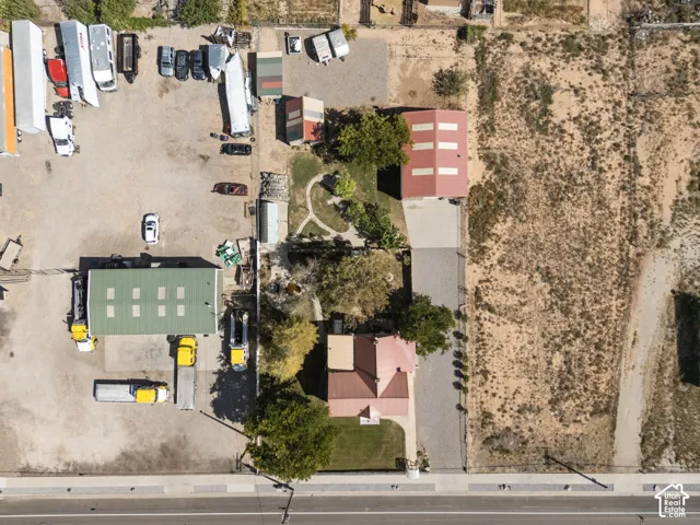 Expansive property featuring multiple structures, a paved drive, and a large undeveloped parcel