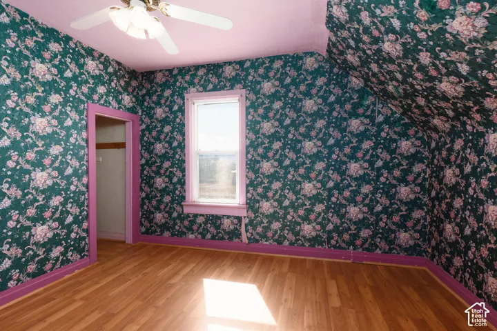 Wood-finish flooring with a ceiling fan light fixture