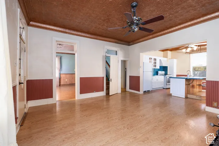 Wood-finish flooring throughout, decorative ceiling, and a ceiling fan
