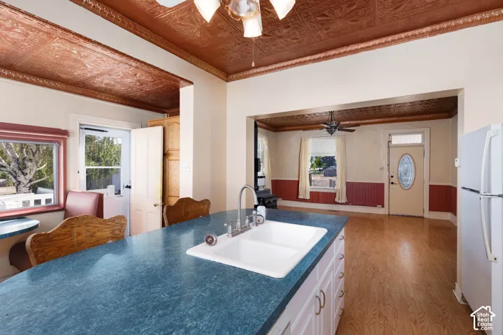 Kitchen island with an integrated double basin sink and a stainless steel faucet