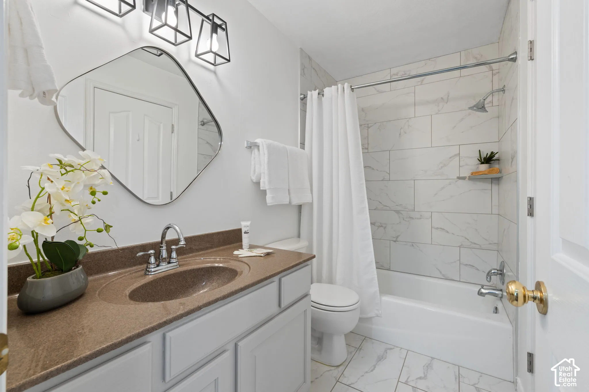 Vanity with a solid surface countertop, undermount sink, and chrome faucet