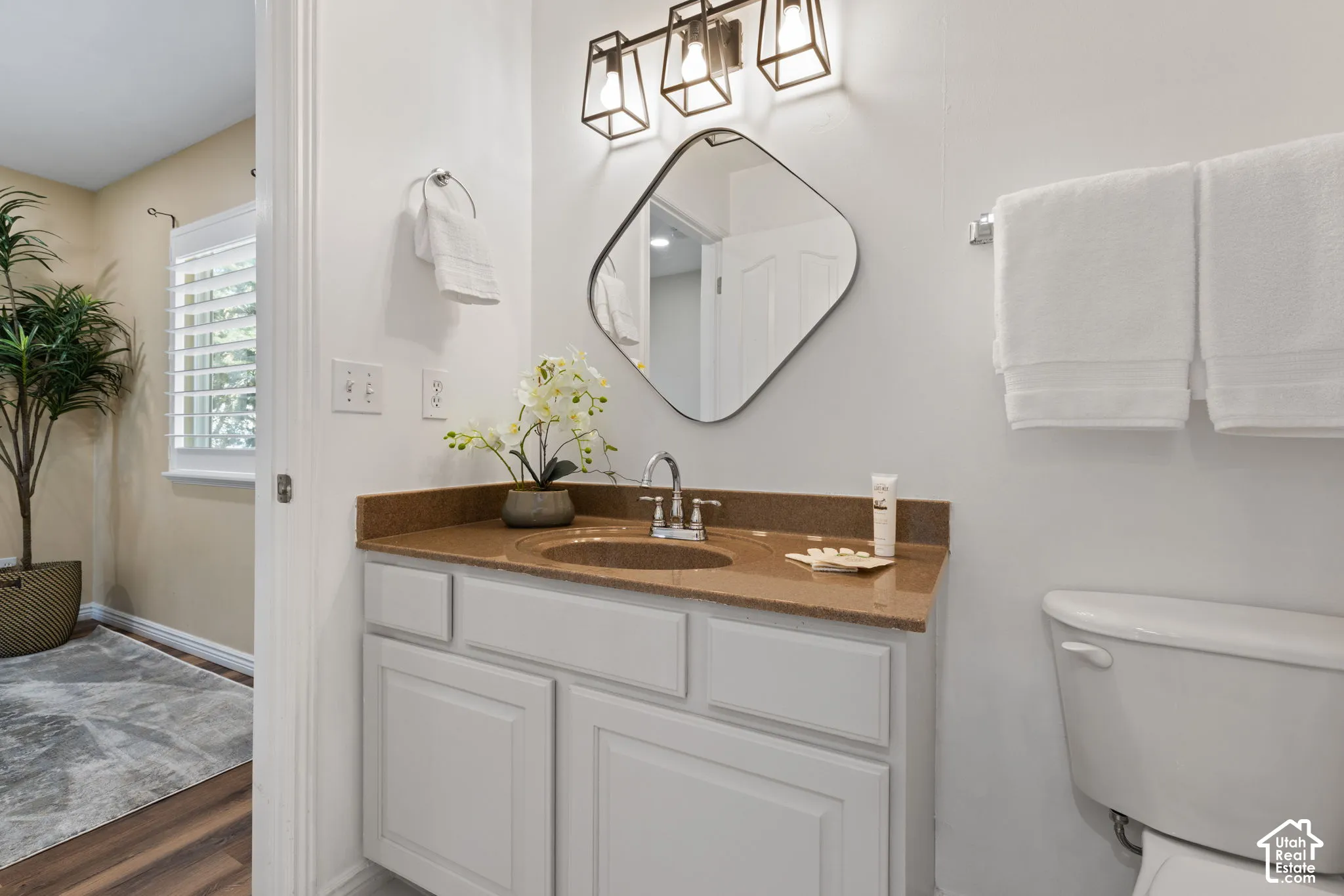 Vanity with a polished countertop, undermount sink, and chrome faucet