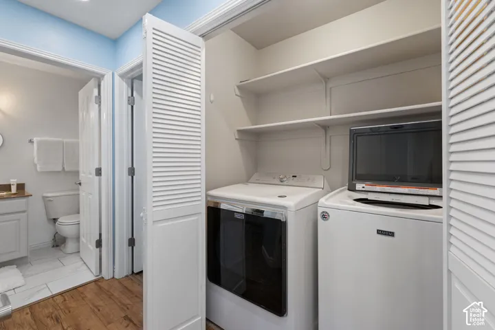 Dedicated laundry area featuring a front-load washer and top-load dryer