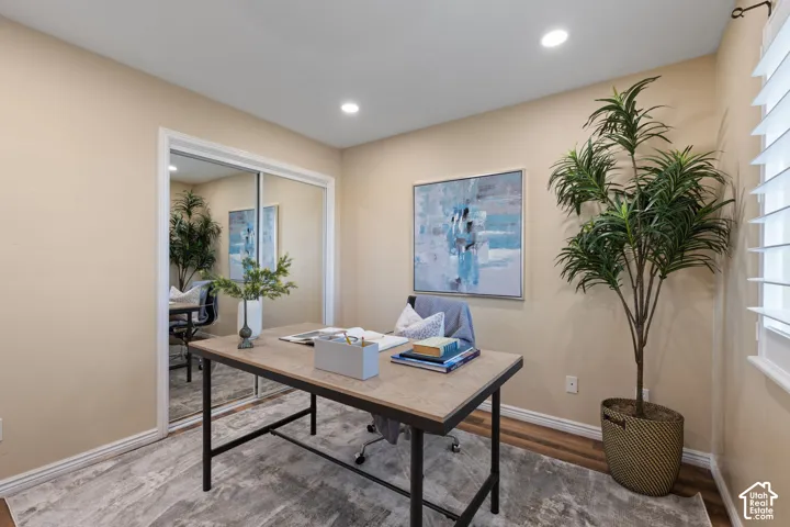 Recessed lighting, wood-finish flooring, and mirrored closet doors