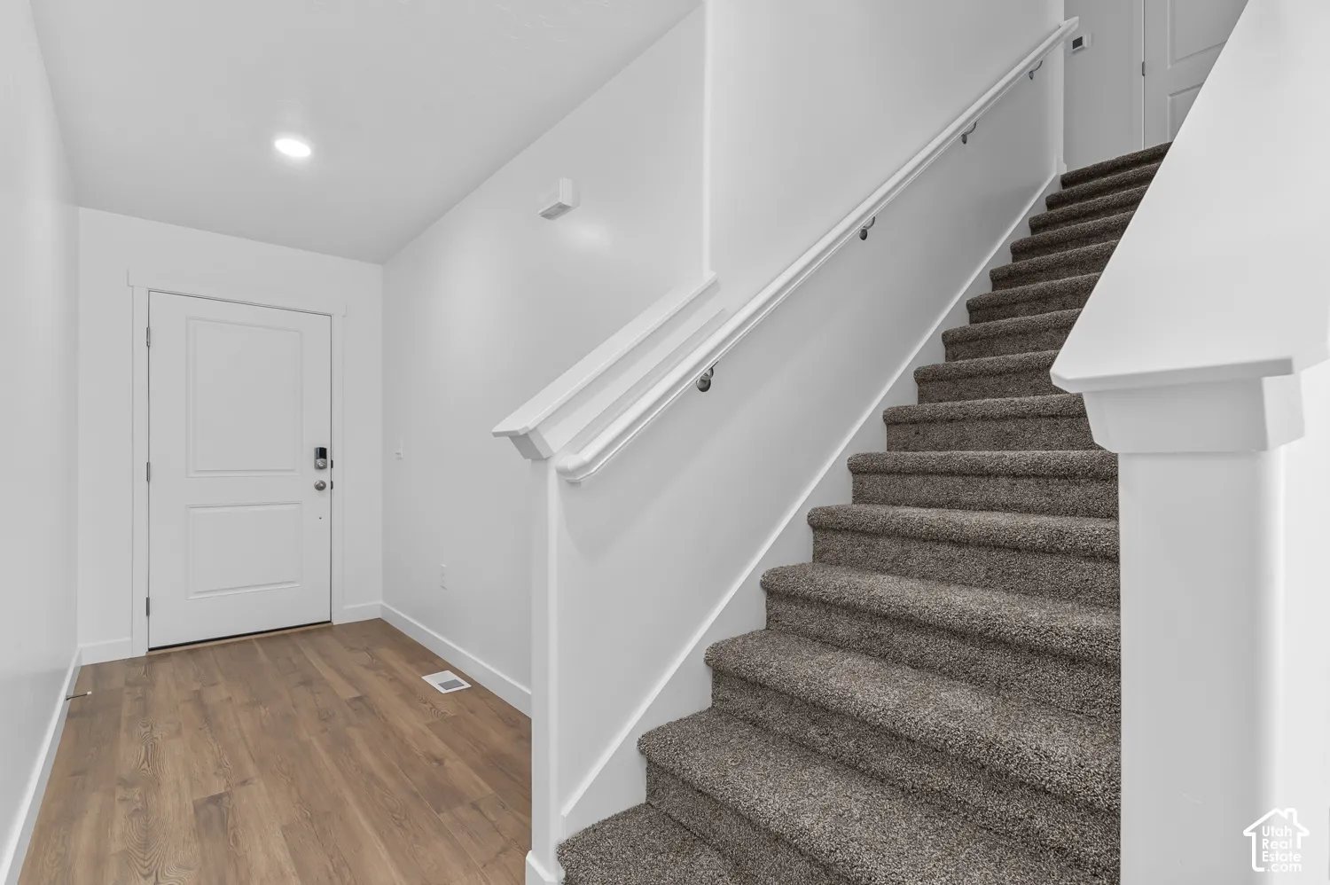 Entryway featuring wood-finish flooring and a contemporary white door