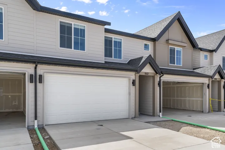 Contemporary exterior with light-colored siding and dark trim accents