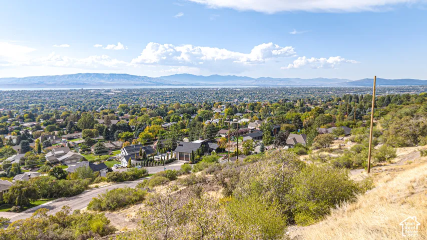 Expansive mountain and water scenery with a residential backdrop