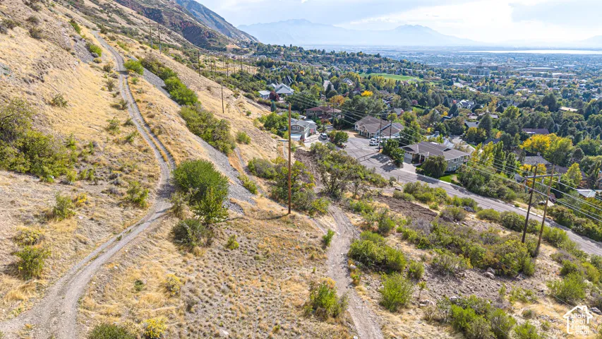 Elevated position overlooking a residential area, distant body of water, and surrounding mountains