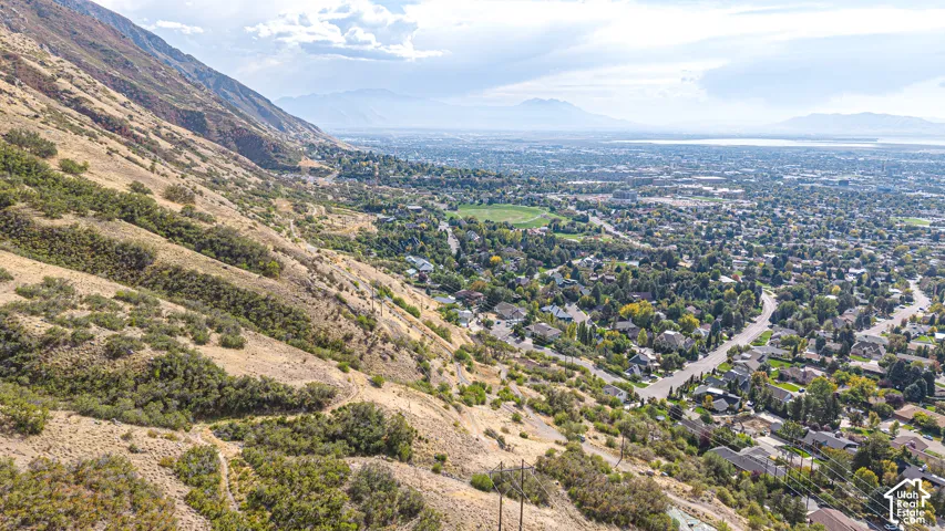 Expansive hillside property featuring natural terrain and distant urban development