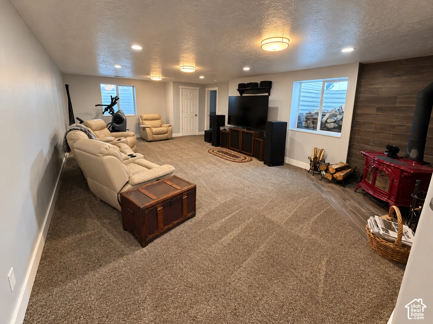 Spacious room with recessed lighting and two surface-mounted light fixtures