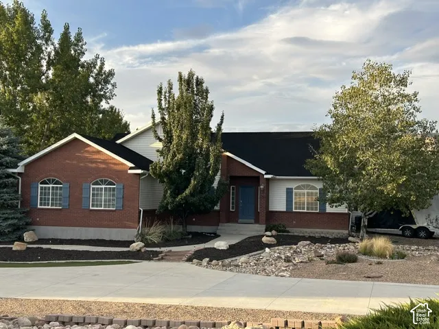 Brick and siding exterior with arched transom windows and blue shutters