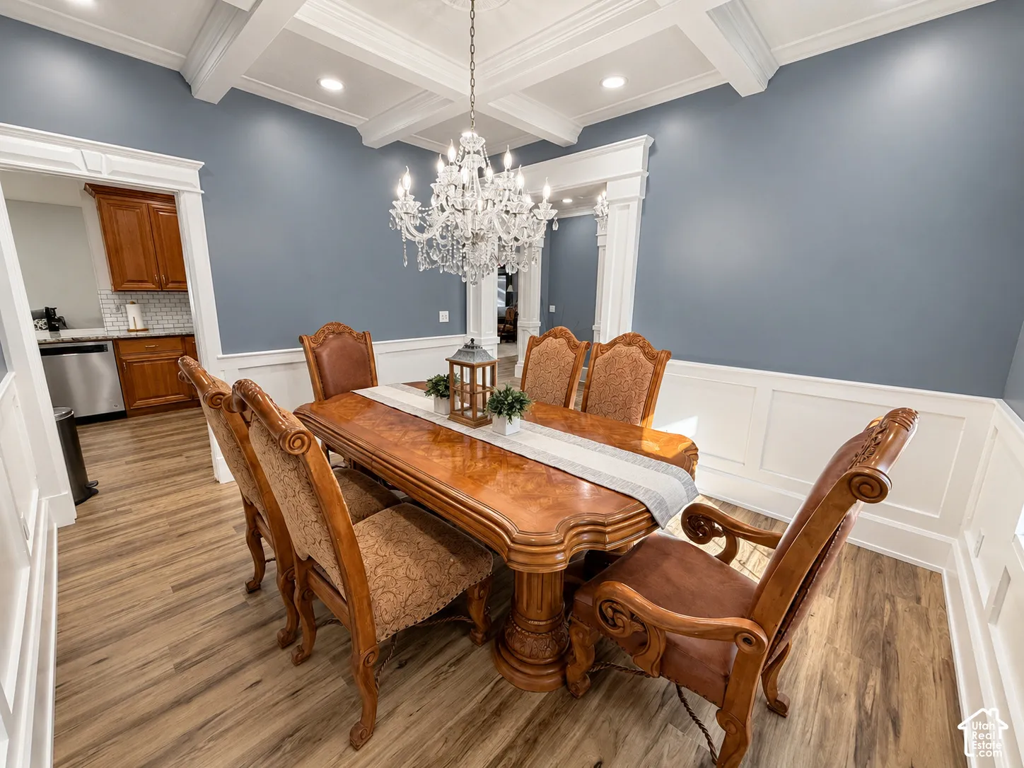 Tray ceiling with recessed lighting and a crystal chandelier
