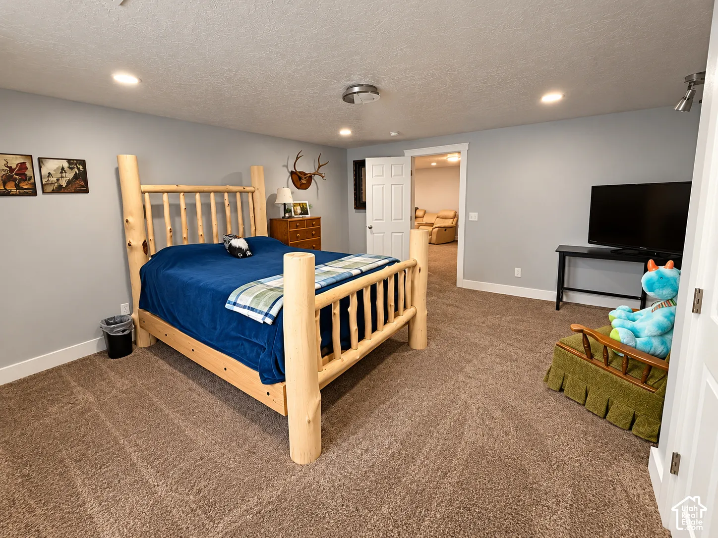 Recessed ceiling lighting, light gray wall paint, and brown carpet flooring