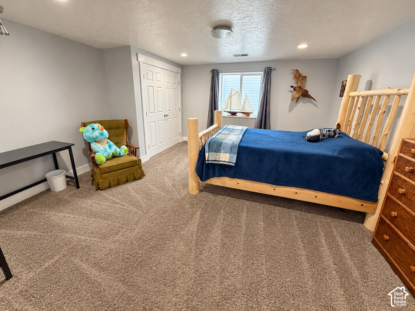 Recessed ceiling lighting, a window with privacy blinds, and a built-in closet with double doors