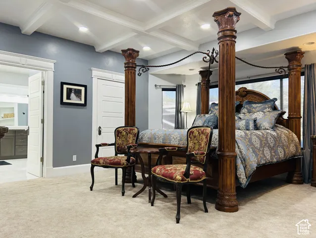 Spacious primary suite with a coffered ceiling, recessed lighting, private en suite bath andwalk in closet.