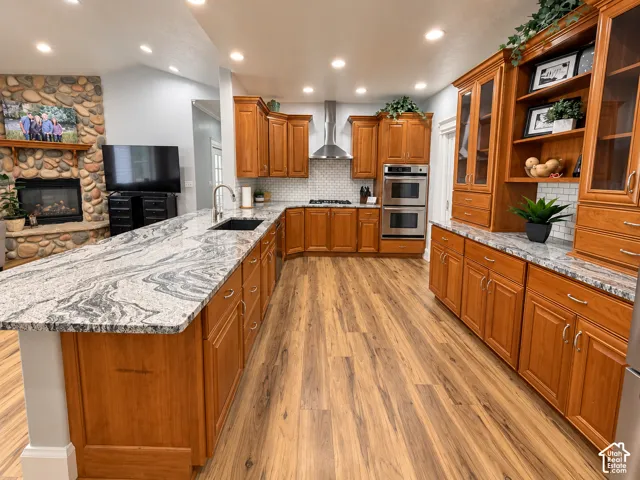 Spacious kitchen with a granite island and warm Cherry Wood cabinetry, open to the familyroom and a river rock fireplace.
