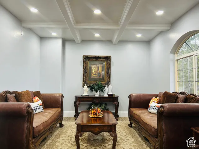 Formal living room with a coffered ceiling and recessed lighting,