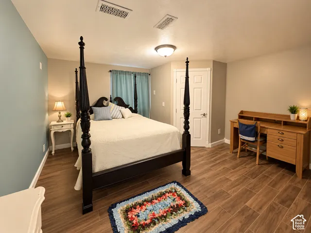 The second of two spacious lower-level bedrooms, with a walk-in closet and wood-look tileflooring.