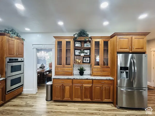 Built-in hutch with glass-front cabinets, open display shelving and granite countertop,conveniently connected to the formal dining room.