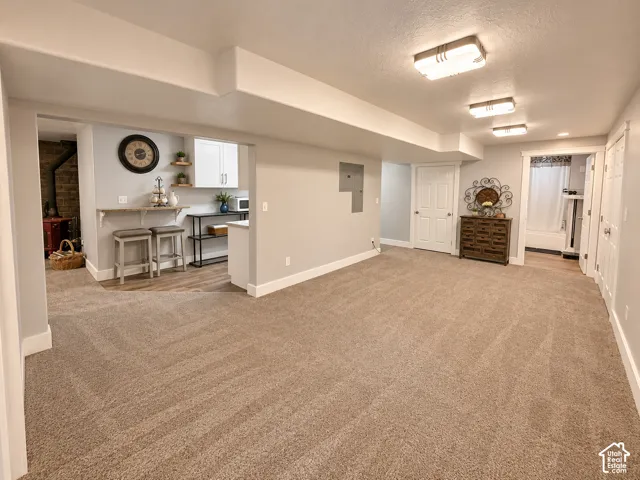 Spacious lower-level game room or exercise room at the bottom of the stairs, open to thesecond kitchen.