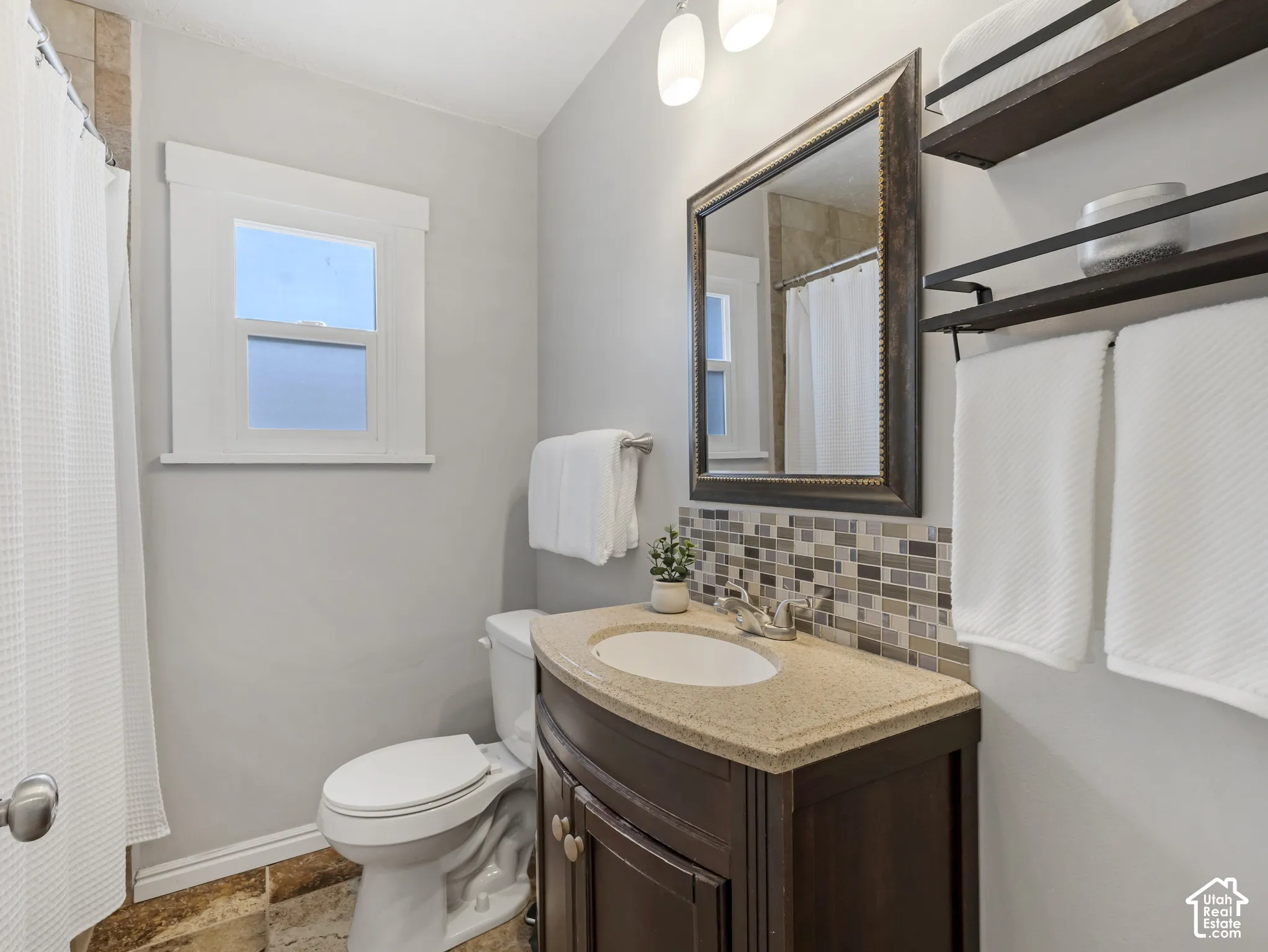 Dark wood-finish vanity with a light-toned countertop
