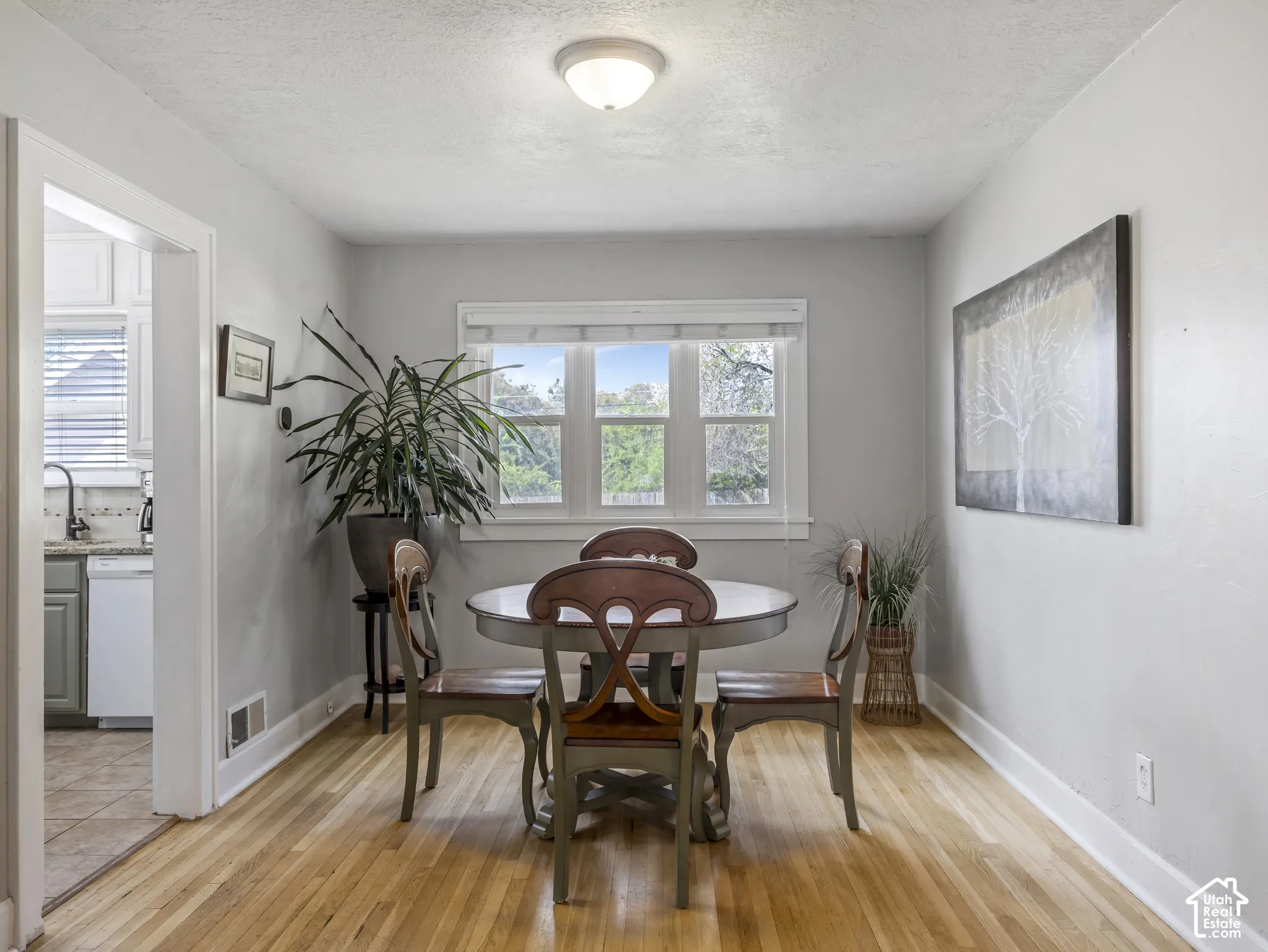 Hardwood flooring throughout, with a window providing natural light