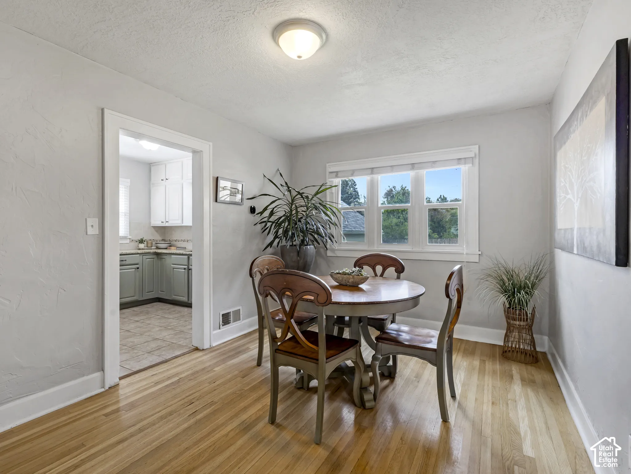 Wood-finish flooring, recessed lighting, and a white-trimmed window