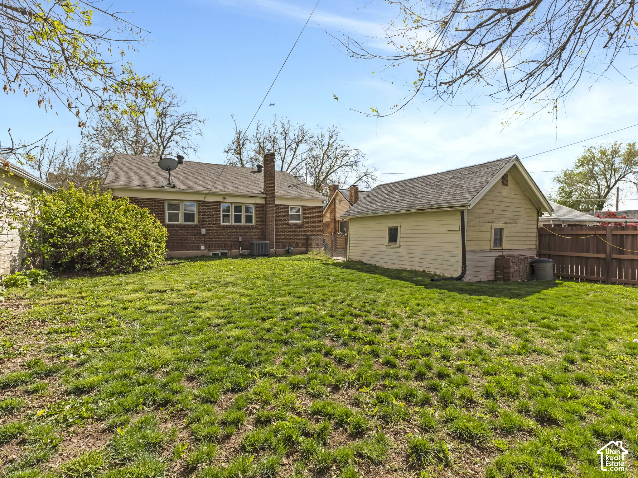 Expansive lawn area with a detached auxiliary building