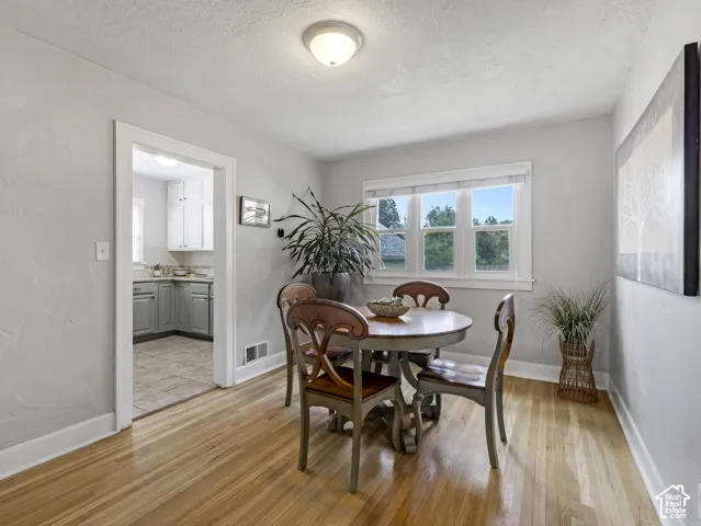 Wood-finish flooring, recessed lighting, and a white-trimmed window
