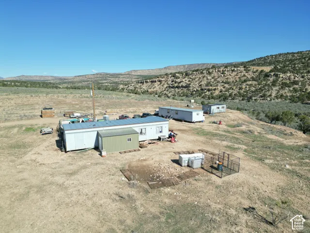 Multiple structures on a spacious, open lot with a distant mountainous backdrop