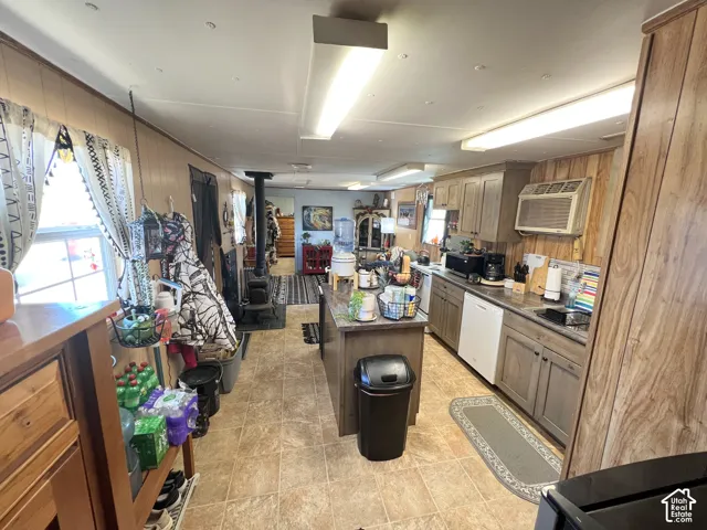 Kitchen featuring wood-finish cabinetry, a large center island, and integrated appliances