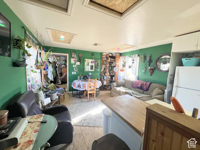 Wood-finish flooring throughout, featuring a kitchen island with a natural wood countertop