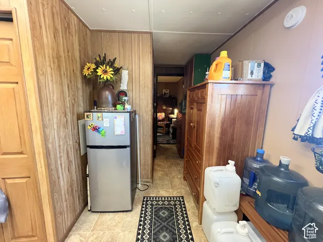 Wood-finish wall paneling with a light-colored door