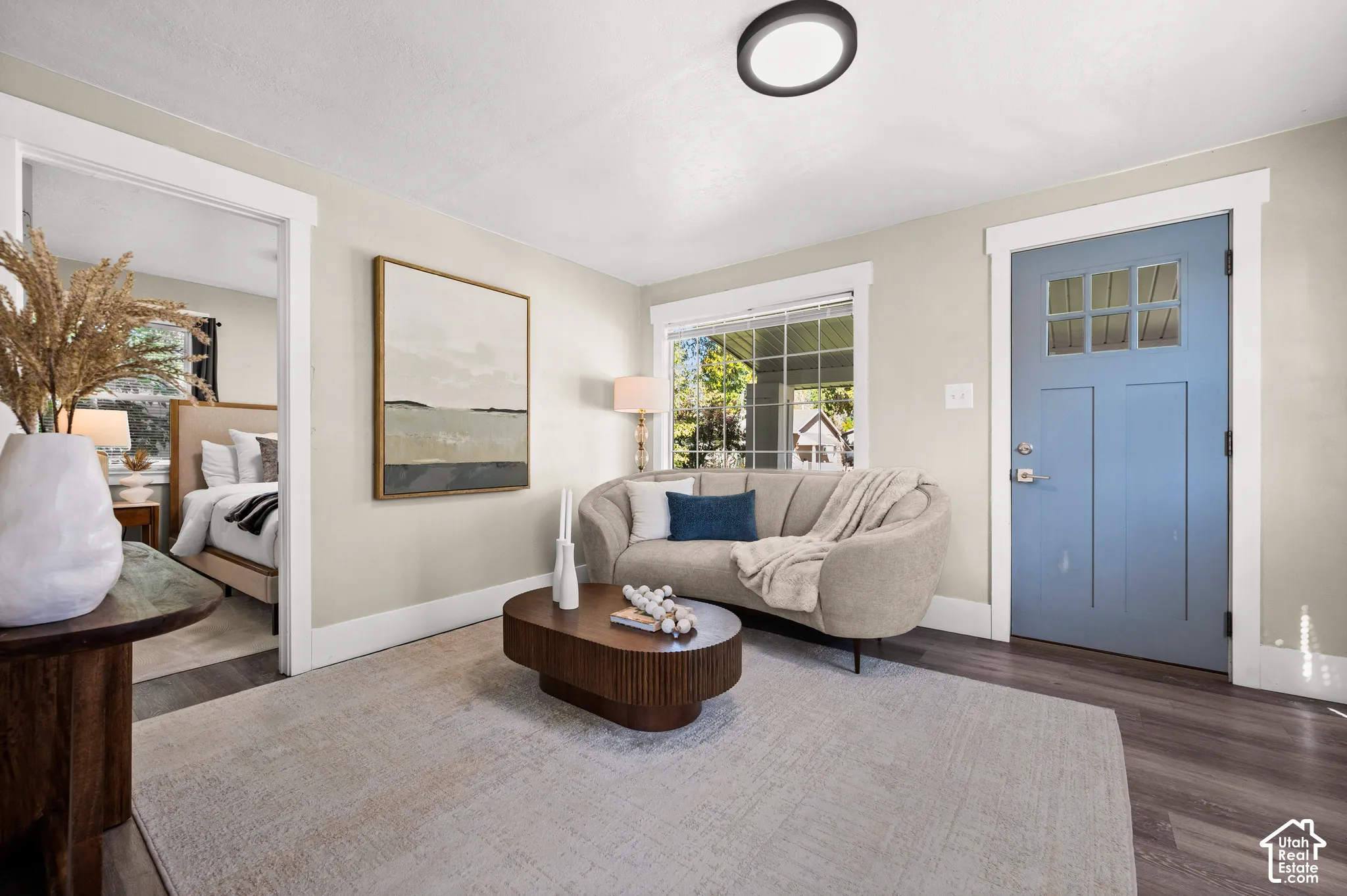 Hardwood-style flooring in a rich tone, neutral wall paint, and recessed lighting