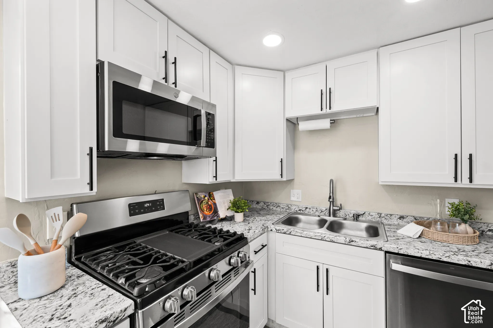 White shaker-style cabinetry with matte black hardware