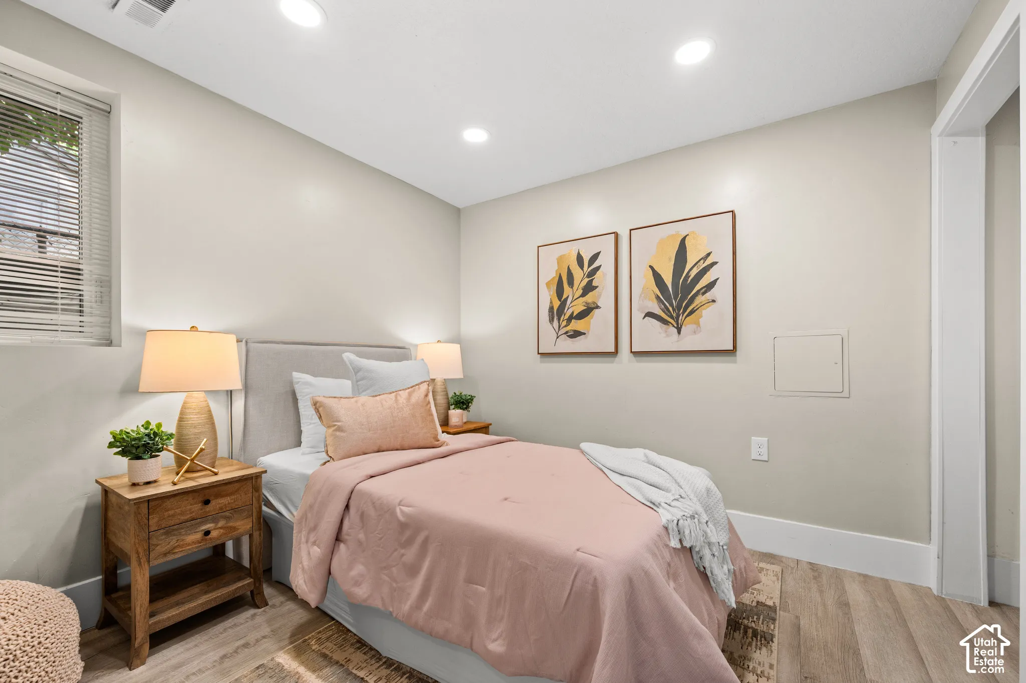 Recessed lighting, wood-finish flooring, and light-toned walls