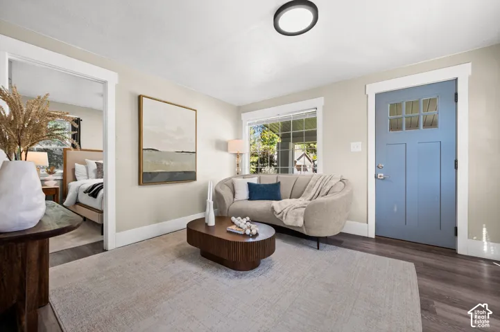 Hardwood-style flooring in a rich tone, neutral wall paint, and recessed lighting