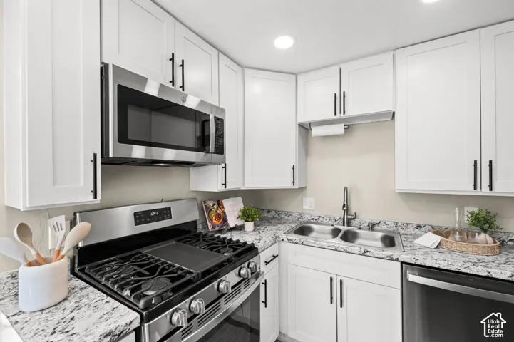 White shaker-style cabinetry with matte black hardware