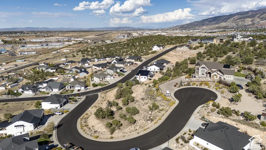 Residential neighborhood featuring paved streets and varied architectural styles with a mountainous backdrop